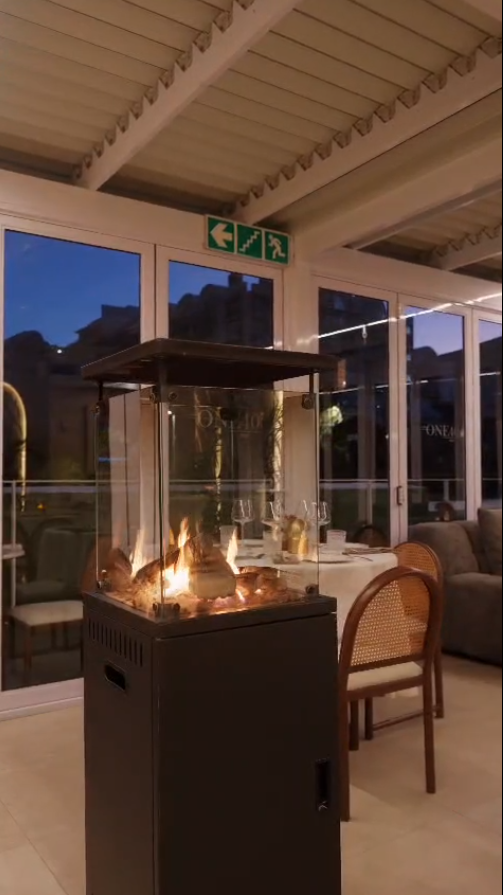 Glass fire feature glowing in the ONE40vue terrace at dusk