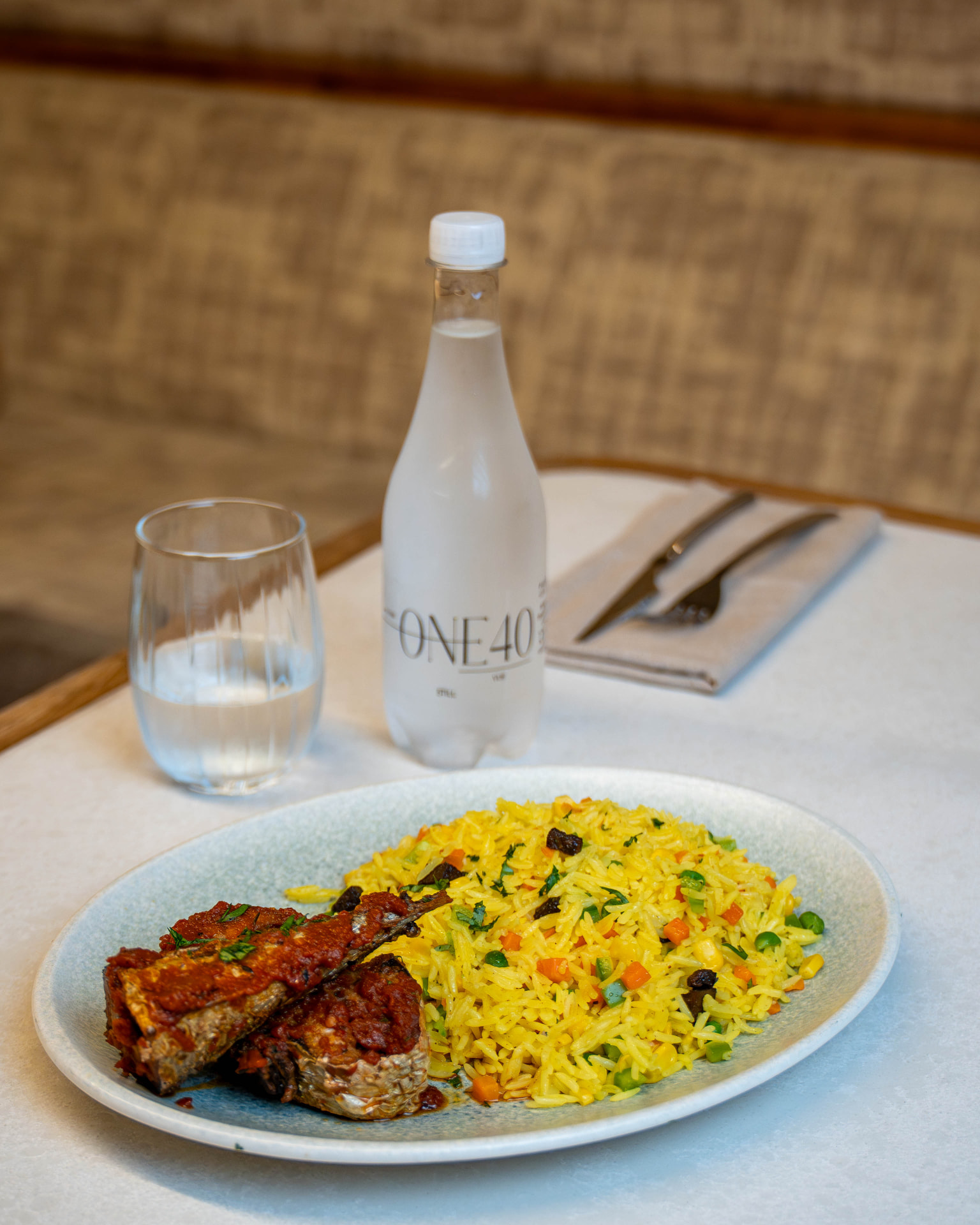 Fragrant fried rice served with fish in spiced tomato sauce
