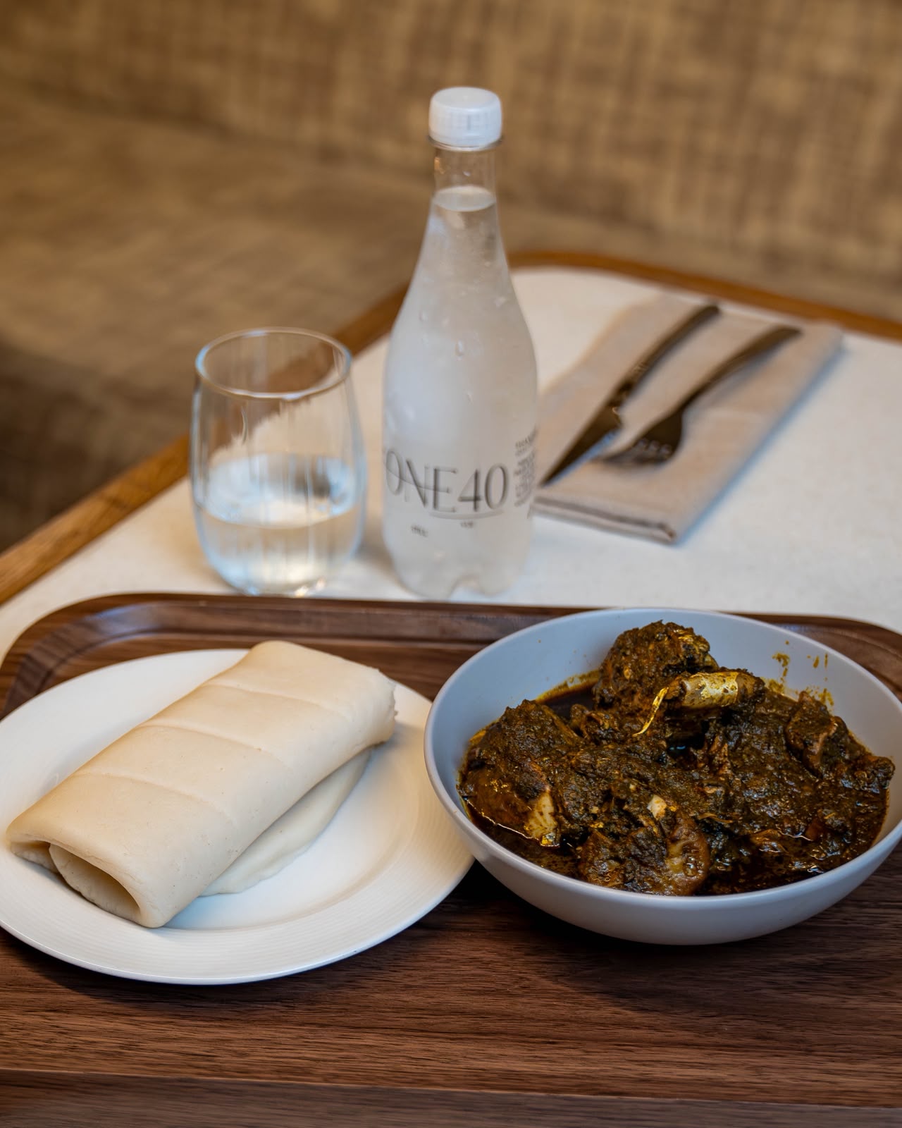 Rich slow-cooked greens stew served with soft pounded dough at ONE40vue